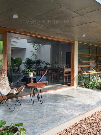 A covered patio space in the Cochin residence provides a seamless transition to the garden, embodying the principles of indoor-outdoor living.