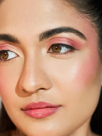 A clean shot of the makeup itself. The face draping with the pink blush creates a beautiful, healthy flush that looks incredibly natural.