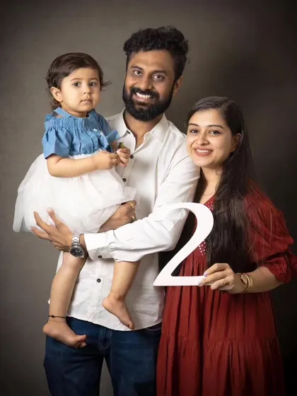 Celebrating a second birthday with a classic family portrait. The number prop adds a fun, personal touch to mark this special milestone.
