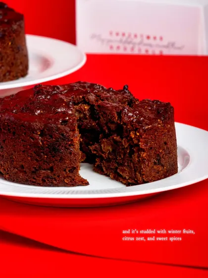 A slice of the fruit cake, showing its moist, dense texture and rich, dark colour.