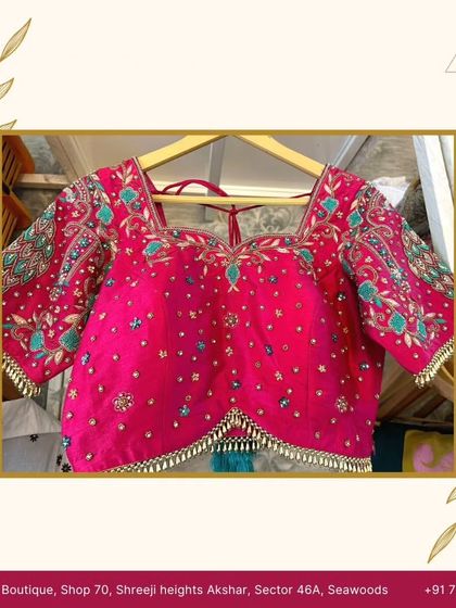 A close-up of a vibrant pink bridal blouse, meticulously hand-embroidered by my team. The intricate patterns and beadwork make it a true masterpiece.