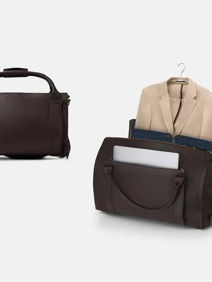 Another version of the garment duffle bag, this time in a rich brown leather. This shot clearly communicates the bag's dual function as both a weekender and a suit carrier, a key selling point.