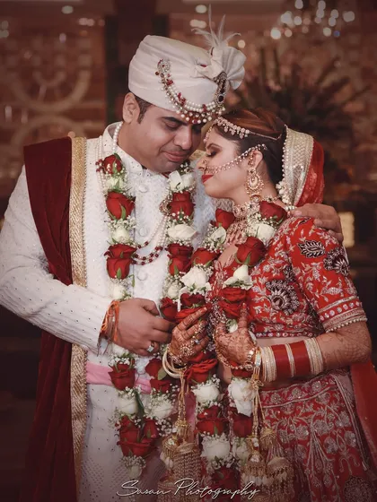 An intimate portrait of the couple after their Varmala ceremony, holding each other close.
