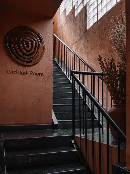 The staircase leading to the Cocktail Room at Idylll is a dark, dramatic passage, building anticipation for the space above.