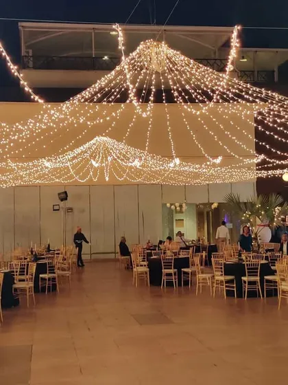 I can transform vast outdoor spaces for large-scale corporate functions. This image shows a gala dinner setup, where I used an extensive canopy of string lights to create a warm, sophisticated ambiance for hundreds of guests, ensuring a memorable evening event.
