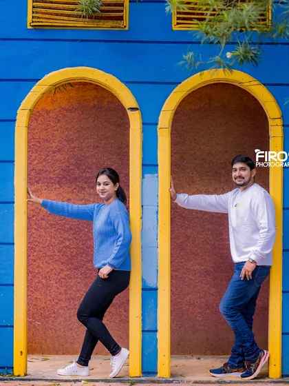 The bright blue and yellow arched doorways offer a quirky and colorful background for a playful and modern couple's shoot.