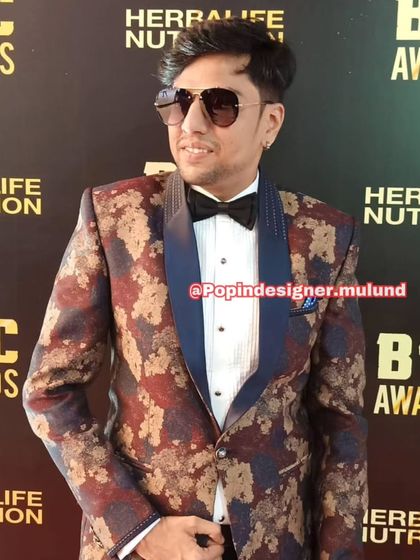 This client is rocking a bold, multi-colored patterned blazer with a navy lapel. It’s a fashion-forward choice for someone who isn't afraid of a little color.