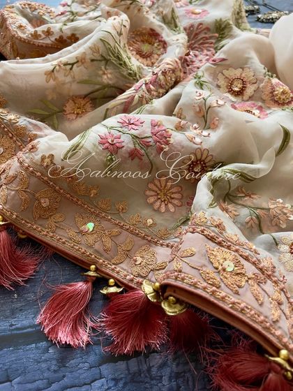 A close-up of the dupatta's corner, showing the tassels and sequin-embellished border.
