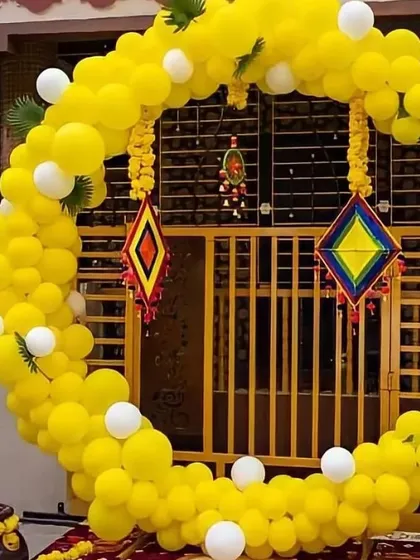 A full view of the C-shaped yellow balloon arch, perfect for framing the entrance or as a main backdrop for your Haldi event. The white balloon accents and green leaf details add a fresh touch.