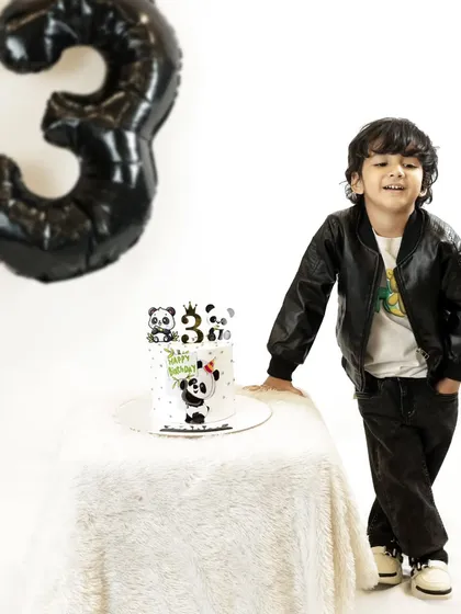 This little guy is rocking his third birthday shoot in a cool leather jacket. The simple black and white panda theme is modern and fun for a growing boy.
