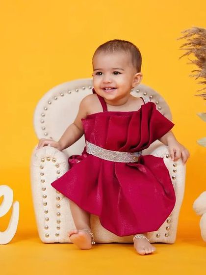 Cuteness overload for her first birthday. A simple, elegant setup with a teddy bear and the number 'one'.