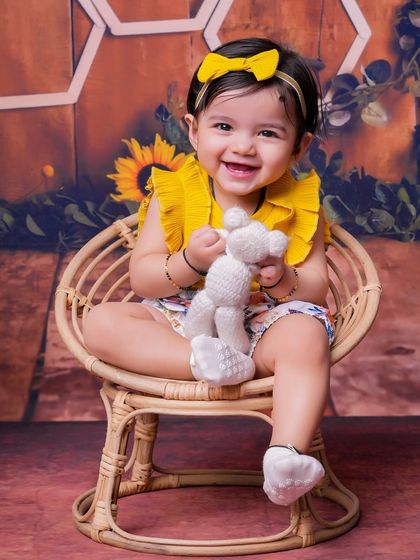 This toddler's smile is as bright as the sunflowers surrounding her. Our themed shoots are designed to be fun and engaging for kids of all ages.