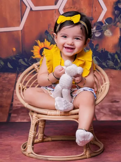 This toddler's smile is as bright as the sunflowers surrounding her. Our themed shoots are designed to be fun and engaging for kids of all ages.
