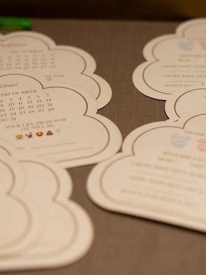 A collection of the cloud-shaped prediction cards, filled with love and well wishes from family and friends. A beautiful memento for the parents.