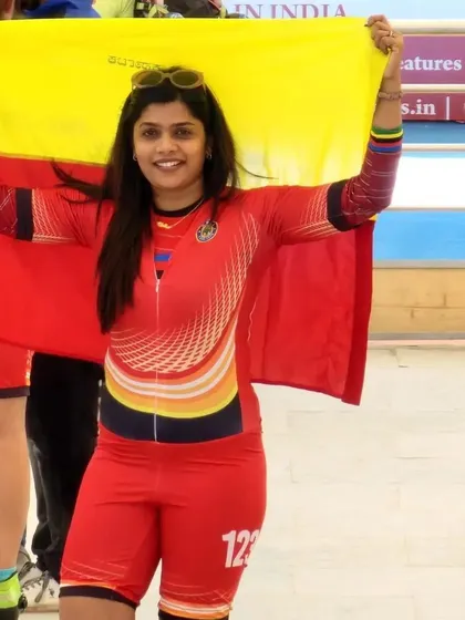 As a coach and a competitor, I lead by example. Here I am, proudly holding the Karnataka flag after competing. I bring the same passion and discipline from my own races to every single training session with my students.