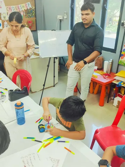 An instructor provides one-on-one guidance, ensuring each child understands the concepts and can successfully build their robotic creation.