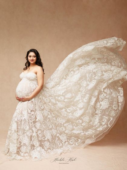 The delicate lace of this white gown flows beautifully in the air, creating a sense of movement and ethereal grace.