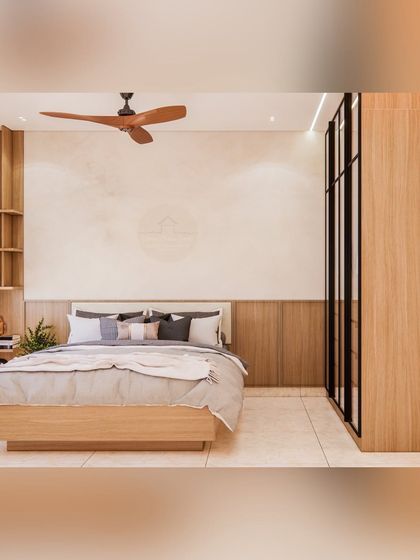 This bedroom showcases a floor-to-ceiling wardrobe with integrated shelving next to the bed. The seamless design maximizes storage while maintaining a clean, uncluttered look, perfect for modern living.
