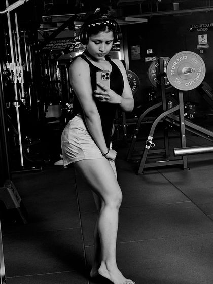 Posing to see the results of hard work on my leg and glute muscles. Consistent training with proper form leads to visible results.