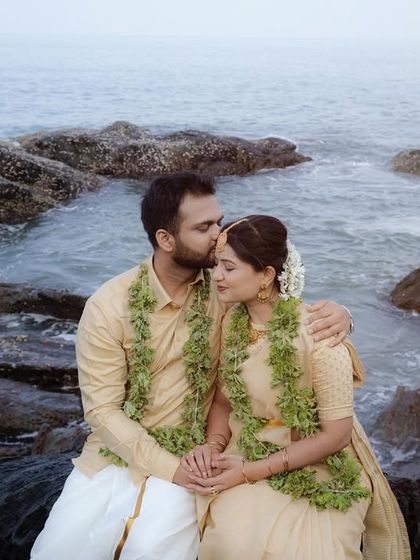 A tender moment between a couple dressed in traditional attire on the rocky shores. This shoot beautifully blends cultural elements with the natural, rugged coastline.