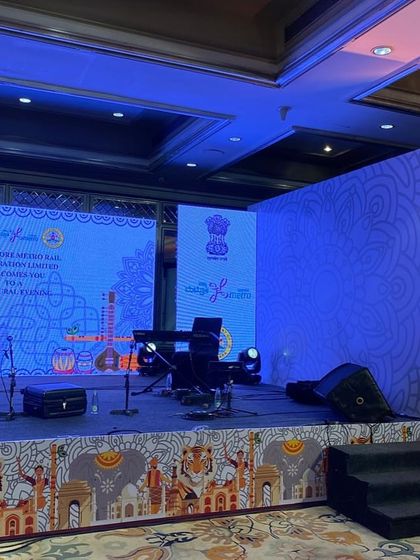 A side view of the stage for the BMRCL event, showing the keyboard and musical instruments ready for the performance. We ensure the stage layout is practical for artists and technically sound.