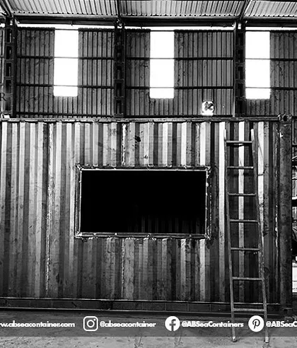 A customized structure takes shape in our workshop. This image shows a container with cutouts for large windows and doors, ready for the next stage of fabrication.