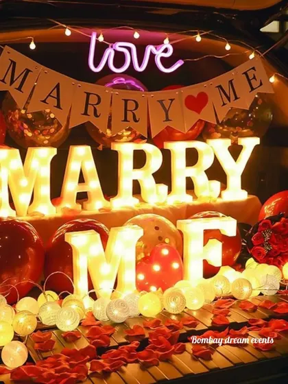 A big surprise can come in a small package. This car trunk decoration is a creative and affordable way to pop the question, featuring marquee letters, a custom banner, and romantic lighting for a private, heartfelt moment.