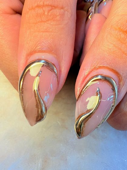 A close-up of our 3D gold chrome art. You can see how the raised metallic element creates a stunning, liquid-like effect on the nail, adding texture and shine.