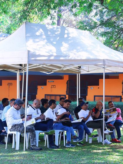 A classroom session held outdoors for a corporate leadership program. We can set up comfortable, shaded seating areas on our lawns for presentations and discussions, offering a fresh alternative to indoor meetings.
