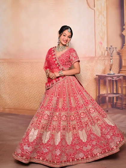 A full-length shot of a classic red bridal lehenga look. We teach not just makeup and hair, but also how the complete look comes together with draping and styling.