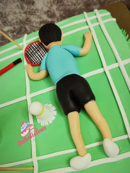 Even the player lying down after a tough match is crafted with detail on this fun badminton cake.