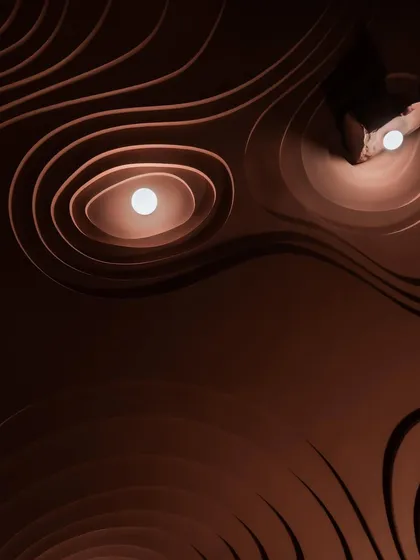 We sculpt with light as much as we do with materials. This is a glimpse of our 'Whispers in Motion' project, where undulating ceiling forms and carefully placed lights create a sense of movement and wonder. This design won us the 'Best Use of Lighting' award, a recognition we cherish.