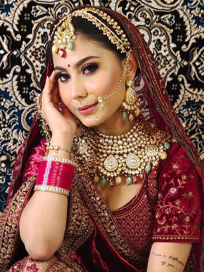 A bride wearing a multi-colored stone and Kundan jewellery set. The intricate details and vibrant colors make this a perfect choice for a mehendi or sangeet.