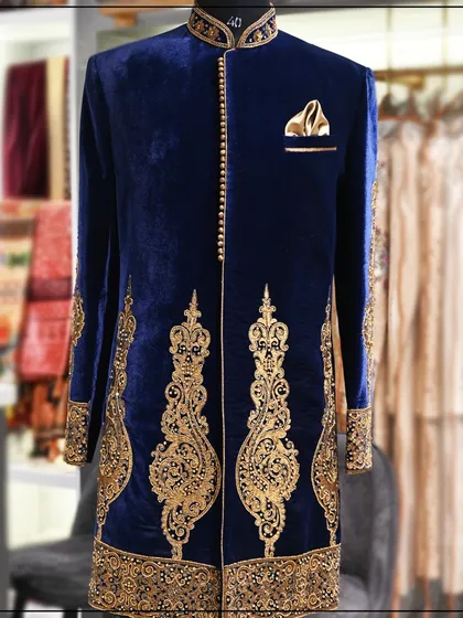 This is for the groom who wants to look nothing less than royal. A bespoke sherwani crafted from rich blue velvet, featuring intricate hand-embroidery that showcases true traditional craftsmanship.