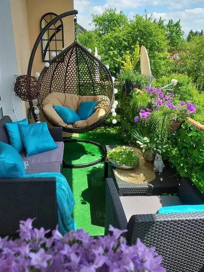 A duplicate of a vibrant and colorful balcony garden, perfect for showcasing how even a small space can be filled with life. The swing chair and plush cushions make it an inviting spot to relax.