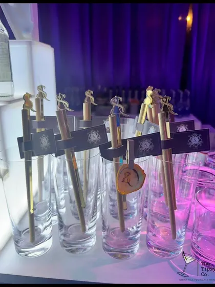Customization is key, even for house parties. These glasses are set up with personalized stirrers and tags, ready for a night of bespoke cocktails and celebration.