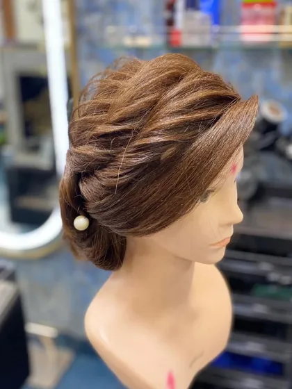 A simple and chic twisted updo by a student. This demonstrates a quick and effective technique for an elegant look.