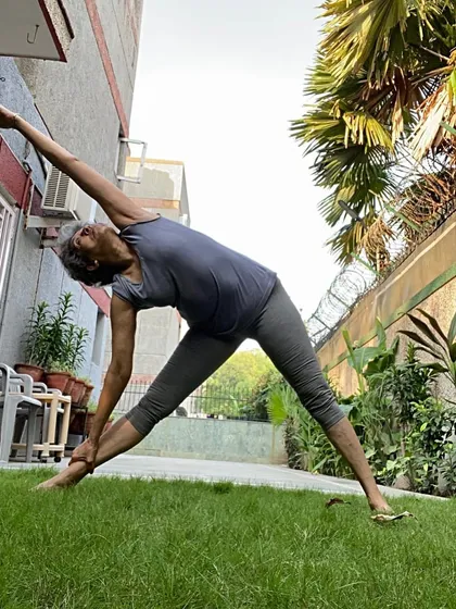 A beautiful side stretch in the garden, a variation of triangle or side angle pose. This lengthens the waist and opens the rib cage.