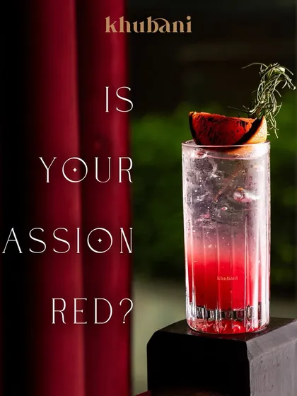 Is your passion red? This striking cocktail, garnished with charred citrus and rosemary, is not just a drink, it's an experience.