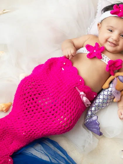 A magical mermaid for her six month milestone. I provide adorable, handmade costumes like this crochet mermaid tail to bring your fantasy themes to life.