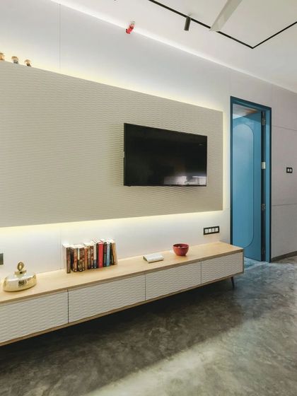 The entertainment unit in the T7 T8 apartment, crafted from rubberwood with a white wave board finish, providing sleek and functional media storage.