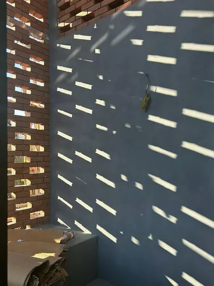 We believe brick is more than just a building material; it is a medium for light and shadow. This detail from our Kolgaon Masterplan shows how a perforated brick screen can transform a simple wall into a dynamic surface that breathes and changes with the sun.