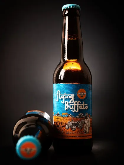 A creative product shot of a beer bottle with dramatic lighting. This style helps a brand stand out from standard e-commerce photos.