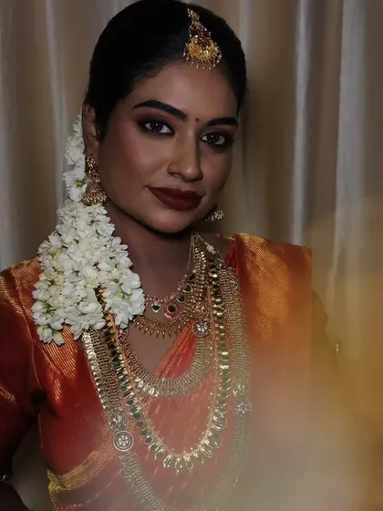 A beautiful, artistic shot of a dusky bride. The lighting creates a lovely contrast, highlighting the glow on her skin and the richness of her traditional attire.