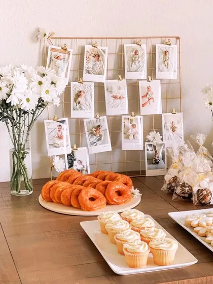 A beautiful way to display cherished memories. This photo grid showcases pictures of the baby's first year, creating a personal and heartwarming detail for the first birthday celebration.