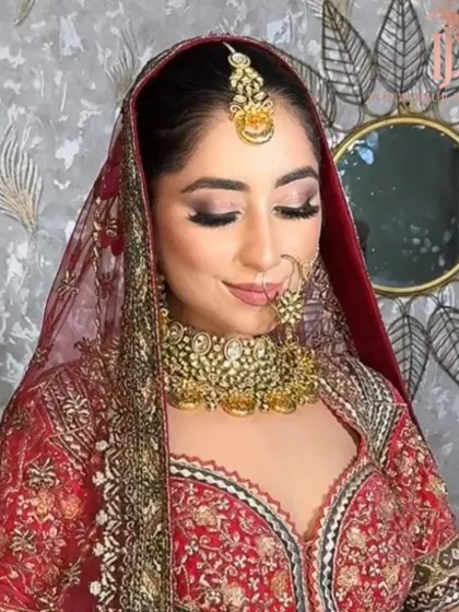 A beautiful bride in her maroon lehenga. This look combines traditional elements with glamorous makeup for a captivating and elegant result.