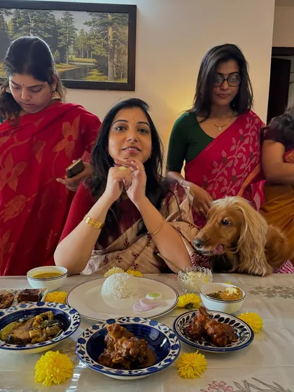 Enjoying the delicious spread at my Bengali Saadh, with Posto hoping for a taste.