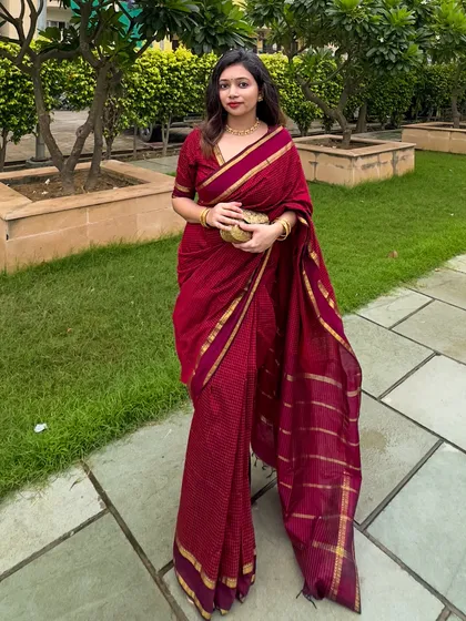 A classic pose showing the elegance of the South cotton saree. The gold border adds just the right amount of festive shine.