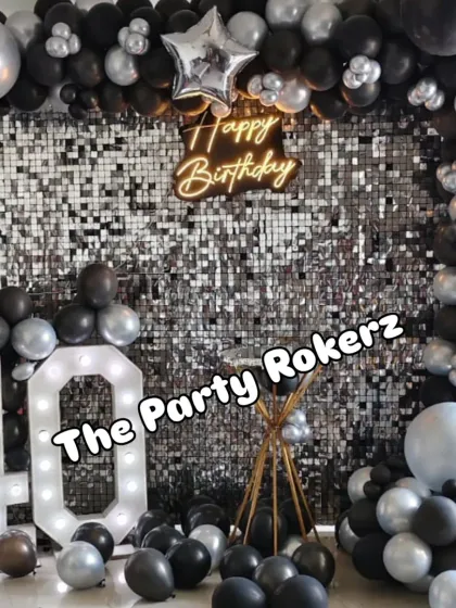 The complete black and silver 40th birthday setup, featuring a sequin wall, a full balloon arch with star foils, and a light-up marquee number.