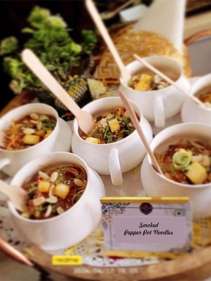 Smoked Pepper Pot Noodles served in individual mugs. This comforting and flavorful dish is perfect for a winter event, served warm as part of our flying buffet.